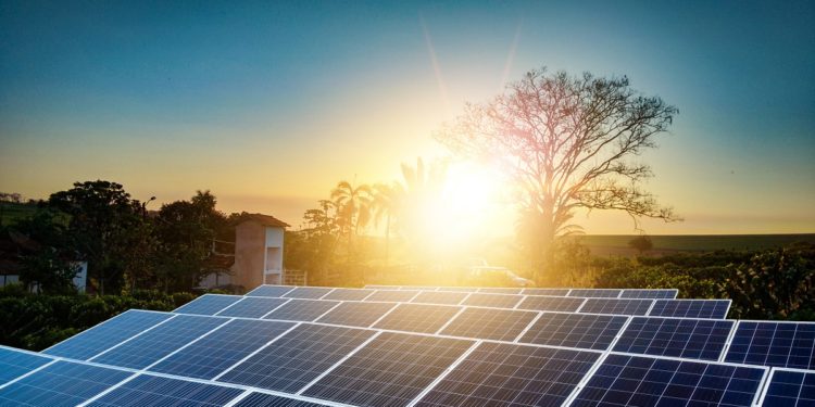 Sunset over Solar energy Farm plant